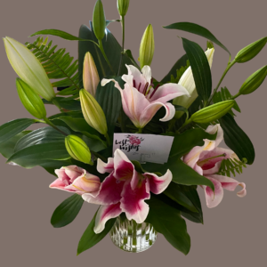 Stunning arrangement, a mass of lillies, pink or white amongst tropical leaves, seventy five dollars plus ten dollars delivery