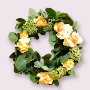 Feminine wreath with rounded leaves, apricot roses and dainty queen anne's lace, elegant and beautiful