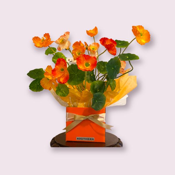 Bright orange box of long lasting artificial poppies, about 25 centimetres in height. Cost of fifty dollars and ten dollars delivery to southern suburbs.