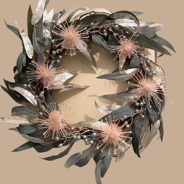 Artificial silver and grey green eucalypt Christmas wreath with pale pink pin cushion flowers sixty centimetres in diameter