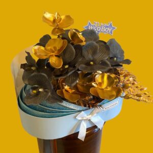 Beautiful pale blue cardboard cracle with blue and gold artificial orchids with an its a boy topper