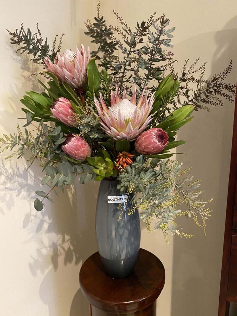 Tall grey vase with selection of native flowers and foilage