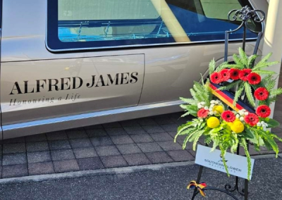 Picture of Crows tribute wreath alongside Alfred James hearse.